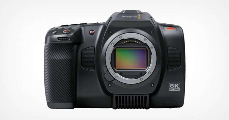 A high-resolution, black digital camera with a visible lens mount and a textured grip on the left side. The camera body shows "Blackmagic Design" branding and "6K Full Frame" marking on the front. The camera has several buttons and controls on its exterior.