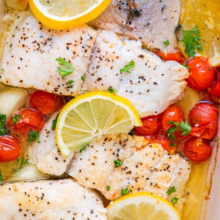 Healthy baked catfish made with cherry tomatoes, lemon and thyem.