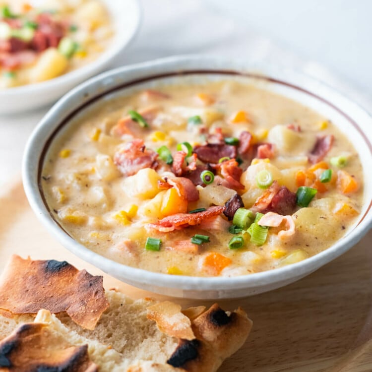 Easy, delicious cheesy ham chowder served in a bowl with pita bread on the side.