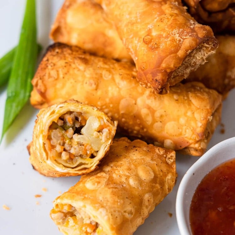 Crispy chicken egg rolls with stir-fried chicken and vegetable fillings.