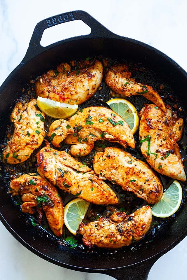Healthy chicken tenders recipes made with spices, garlic and butter in a skillet.