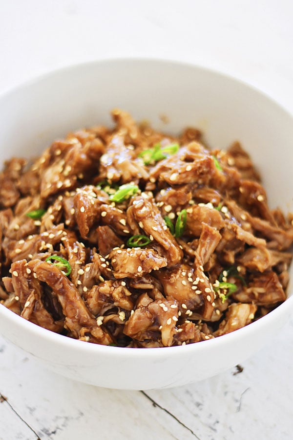 Asian style slow-cooked Crock Pot Honey Sesame Pulled Pork with honey sesame sauce.