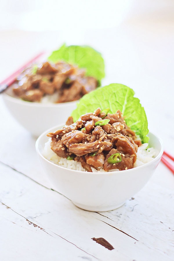 Easy and healthy Crock Pot recipe for Honey Sesame Pulled Pork in a bowl.