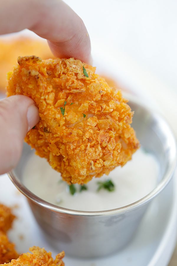 Close up tortilla chip-crusted chicken bites.