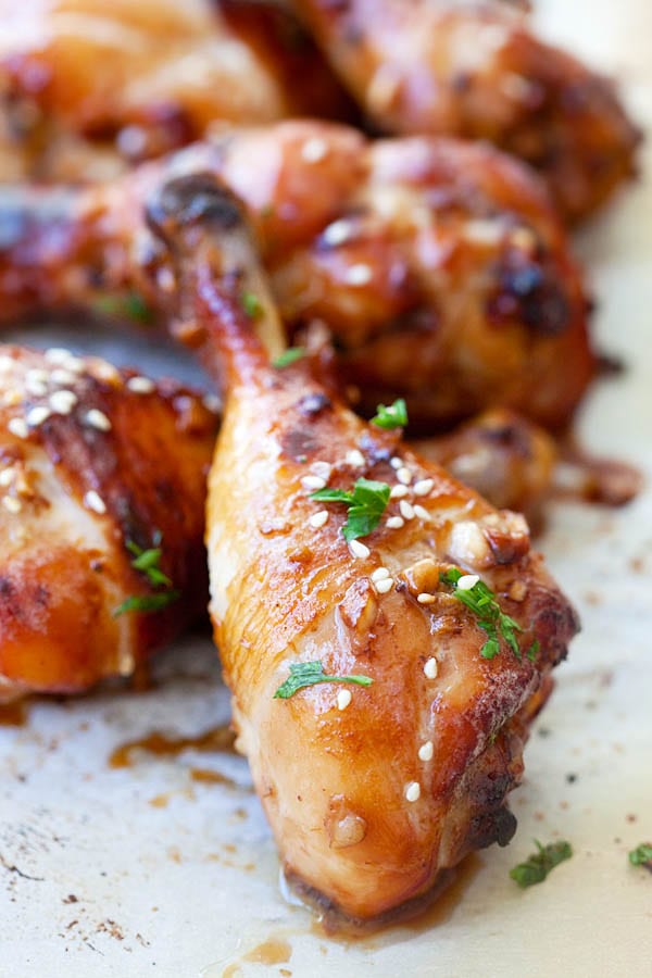 Close up baked chicken drumsticks with ginger garlic brown sauce marinade.