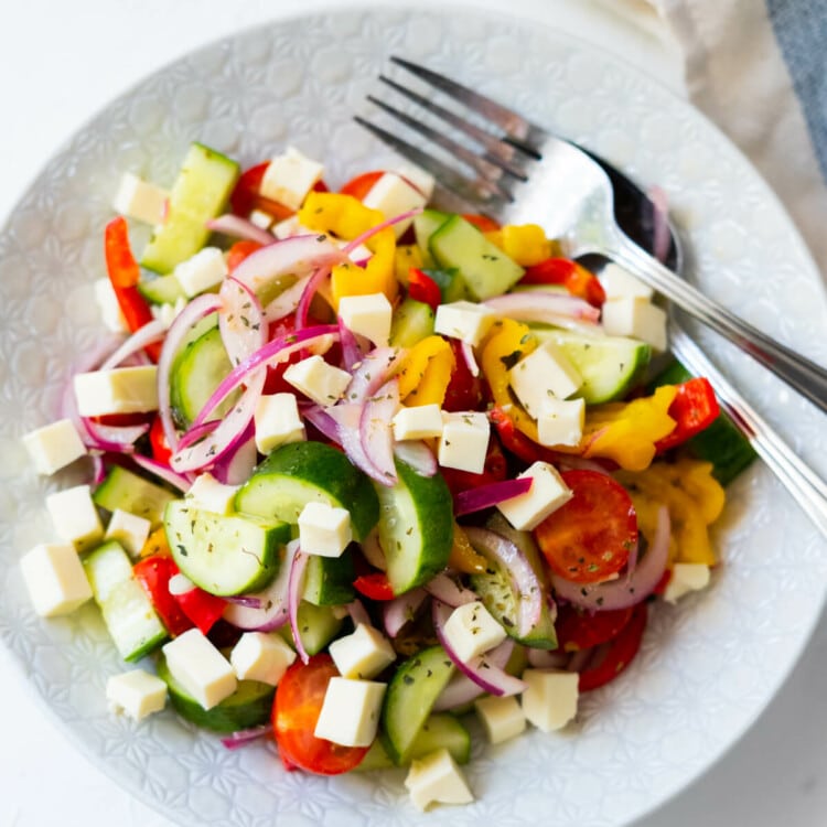 Refreshing Greek salad made with cucumber, bell peppers and cherry tomatoes.