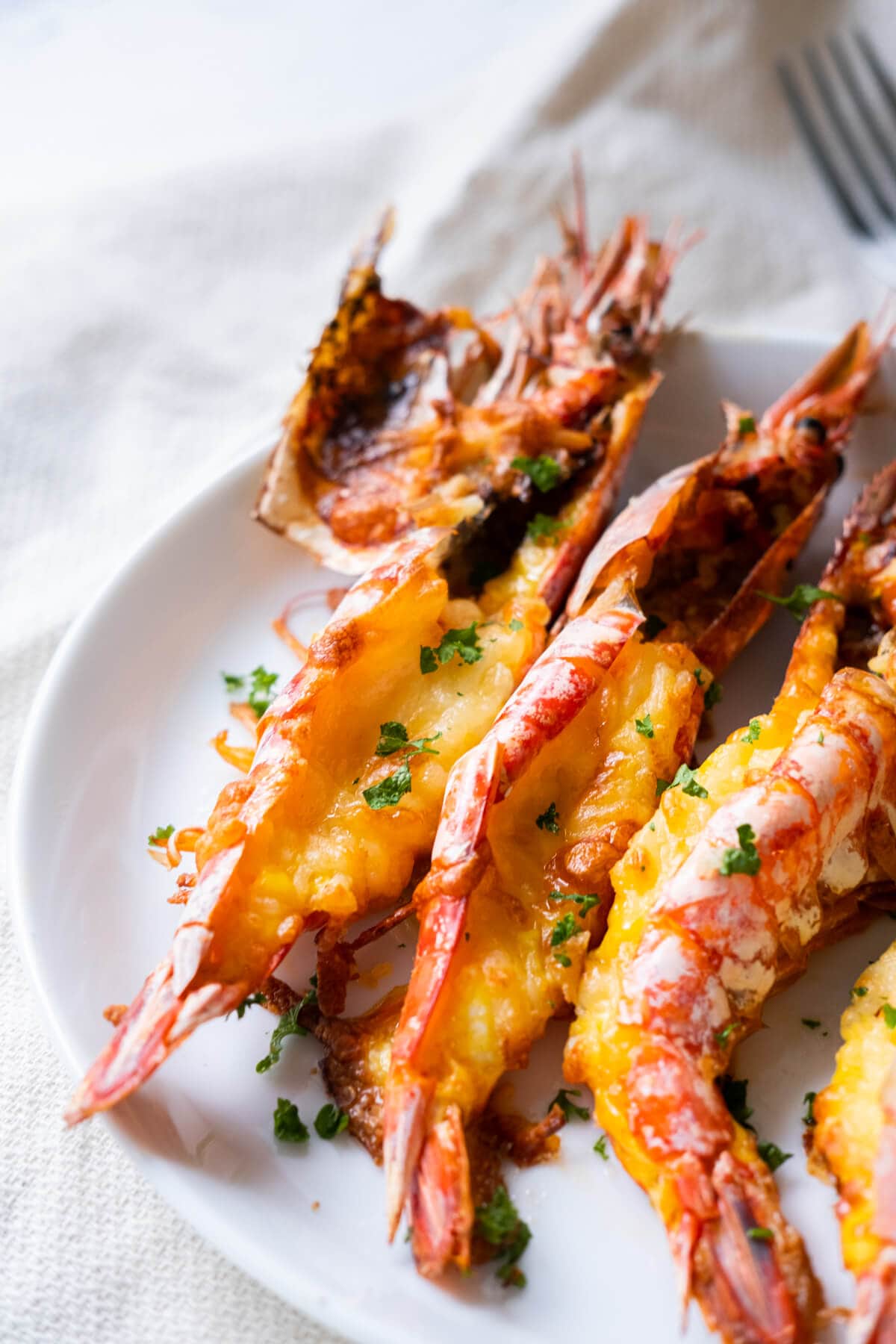Grilled cheese prawn with cheese melted on top. 