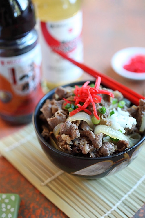 Japanese teppanyaki style beef stir fry with brown Japanese sauce on top of a bowl of steamed rice.