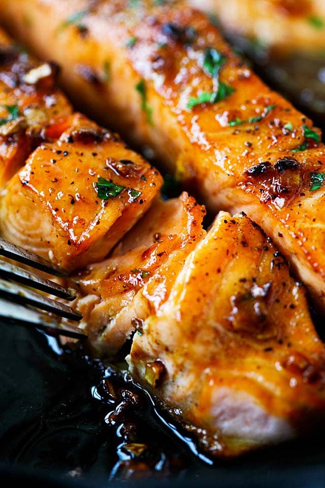 Salmon recipe with honey garlic sauce on a skillet.