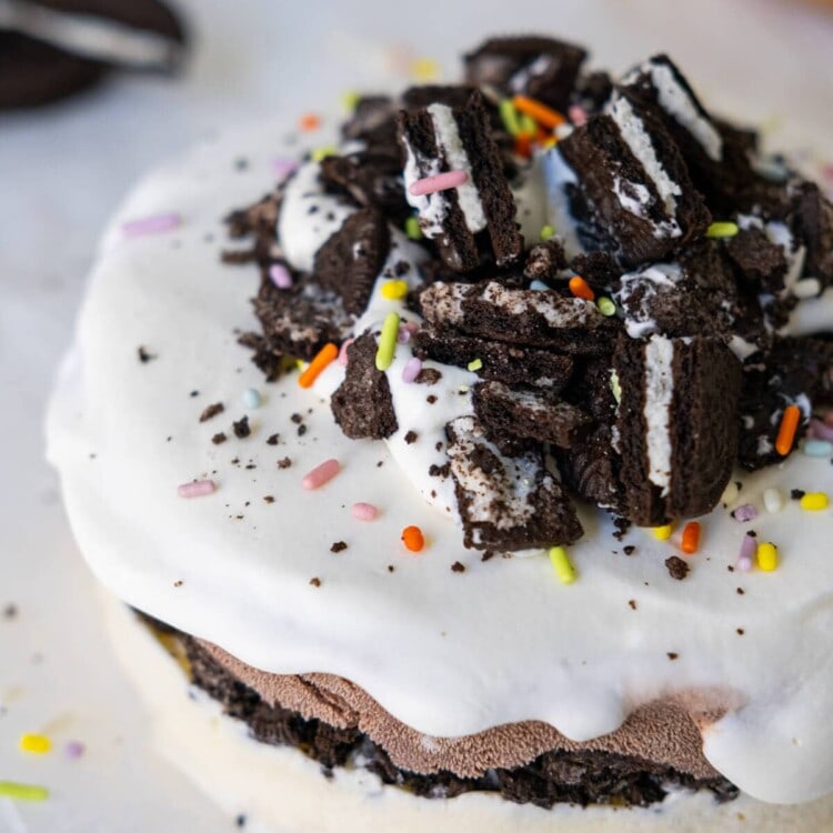 Ice cream cake with Oreo crumbs and sprinkles on top.