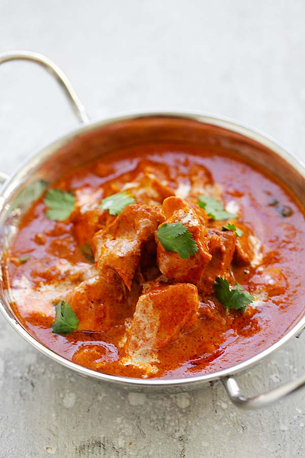 Delicious Instant Pot butter chicken in a silver Indian curry serving ware ready to serve.