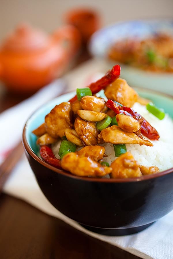 Chinese stir fry Kung Pao Chicken with dried red chilies, roasted peanuts in Kung Pao Sauce on top of steamed rice.