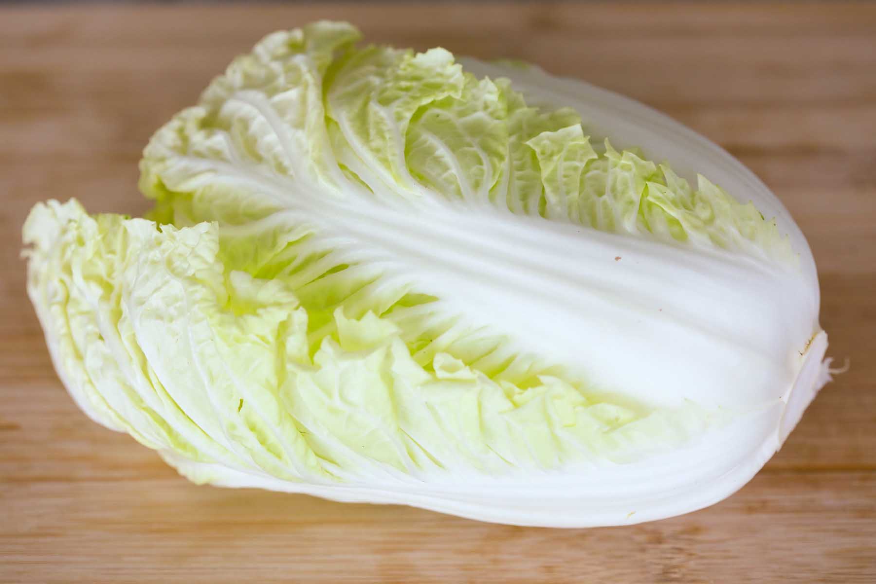 Napa cabbage on a cutting board.