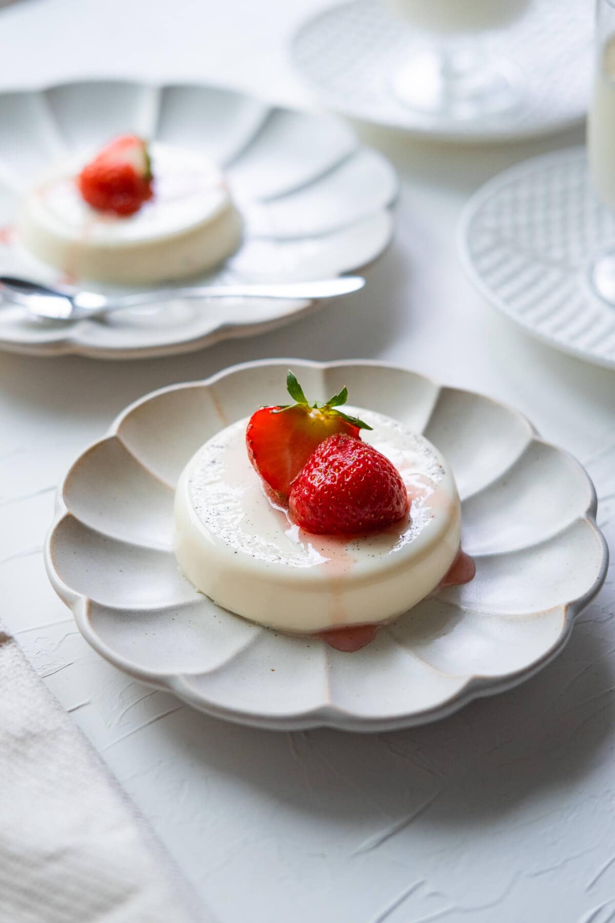 Classic panna cotta served with strawberry and syrup on top. 