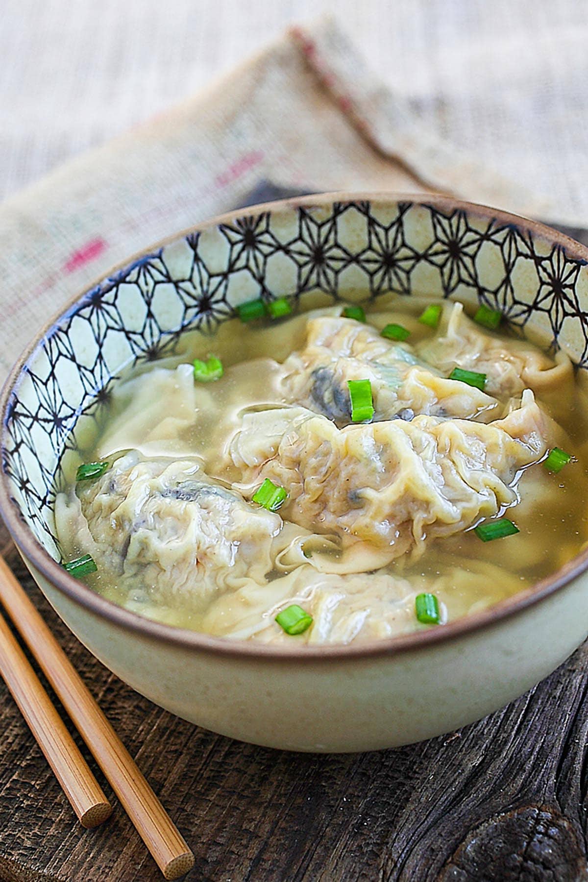 Delicious and easy homemade Chinese pork dumplings soup served in a bowl.