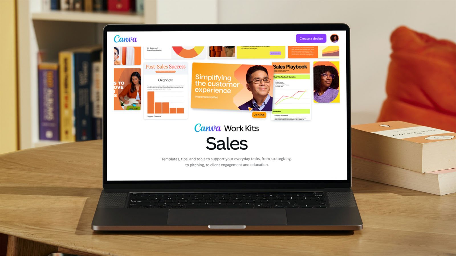 A laptop displaying the Canva website on its screen. The webpage shows various templates and tools for sales, including charts and infographics. The main heading reads "Canva Work Kits: Sales." The laptop is on a wooden desk with books and a bookshelf in the background.