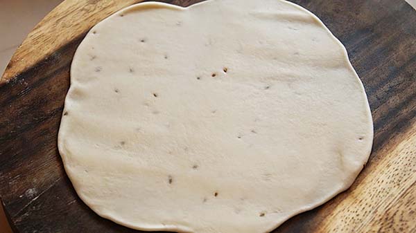 Homemade samosa wrapper and samosa dough on a flat surface, ready to wrap samosas.