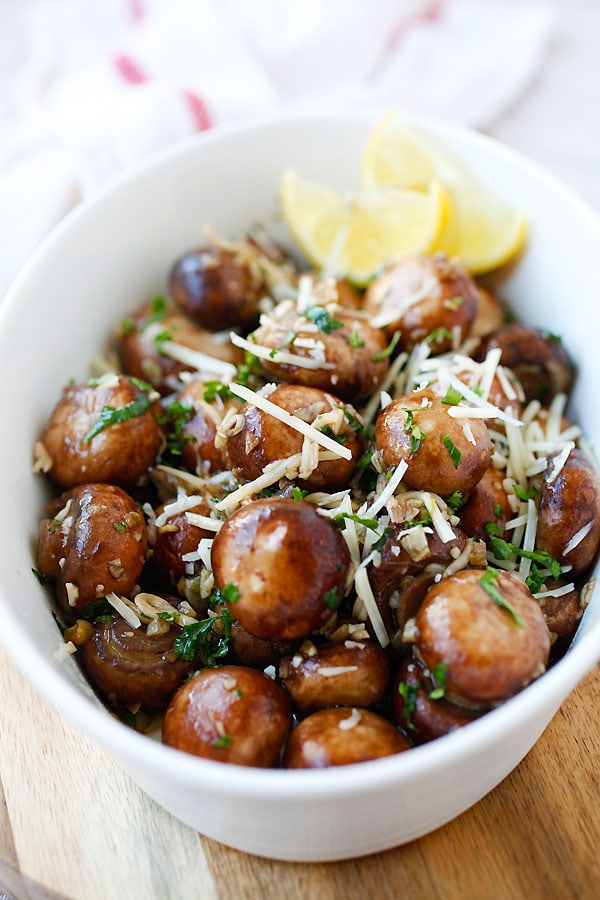 serving dish of fresh mushrooms cooked with garlic and fresh herbs, topped with Parmesan cheese
