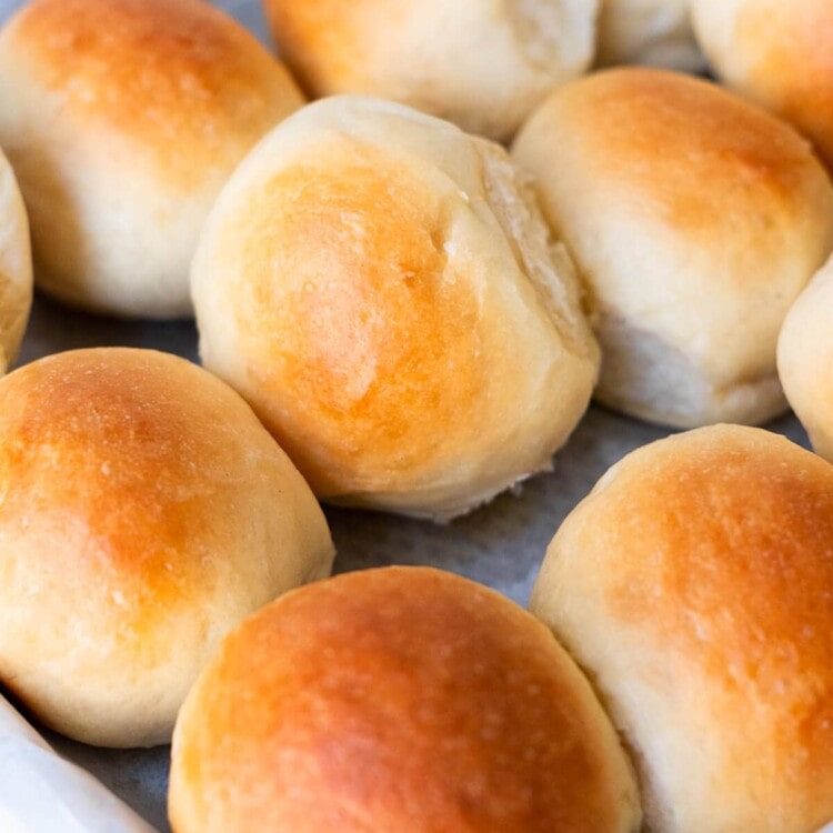 Golden brown slider buns in a baking pan.