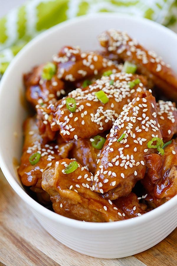 Slow Cooker Honey Sesame Chicken Wings in a sticky savory honey sesame sauce in serving dish.