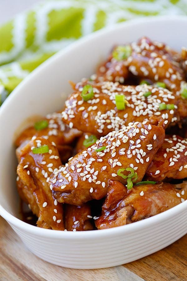 Easy and quick chicken wings in a sticky savory honey sesame sauce garnished with sesame seeds.