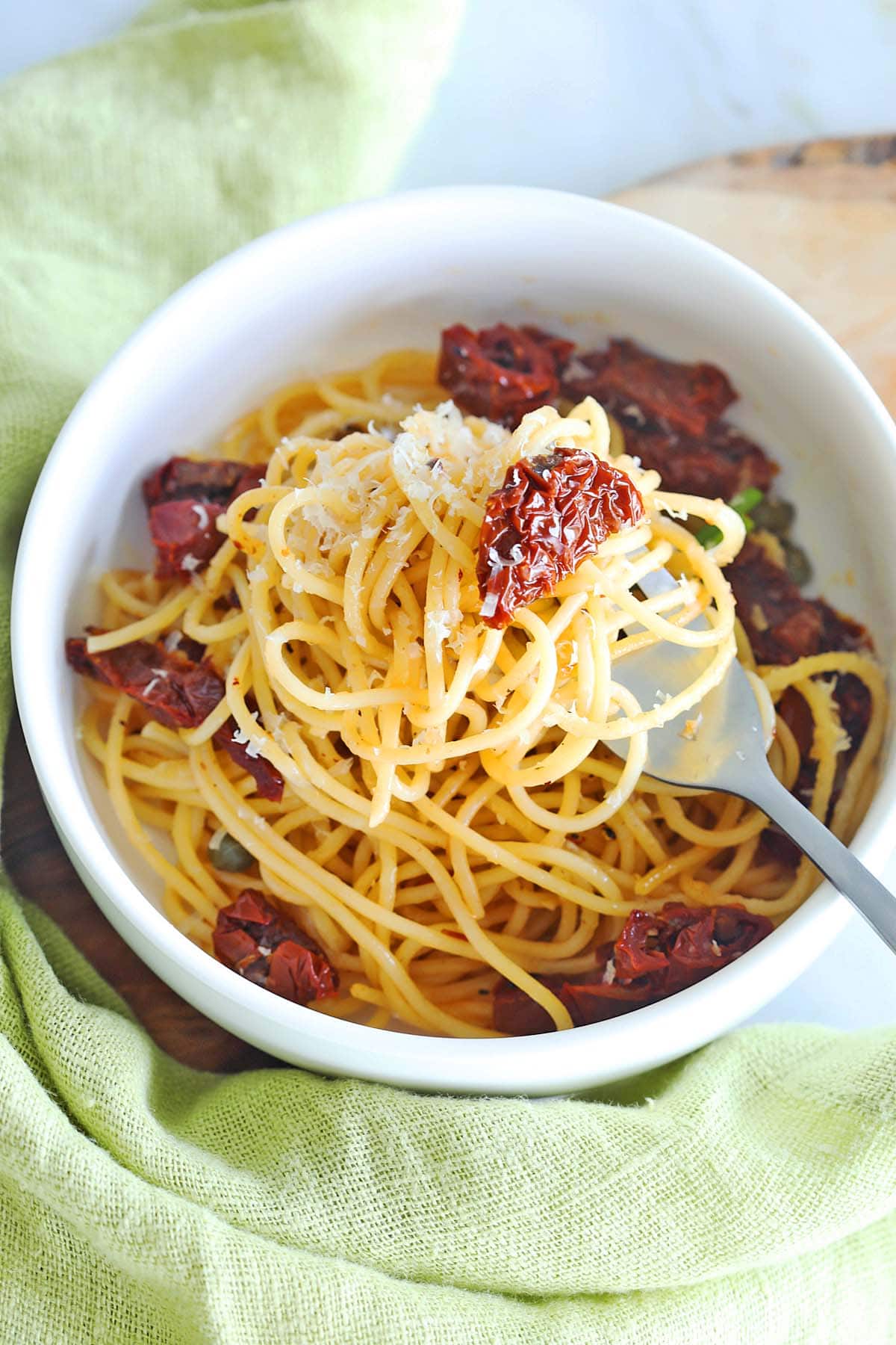 Sun dried tomatoes on top of pasta.