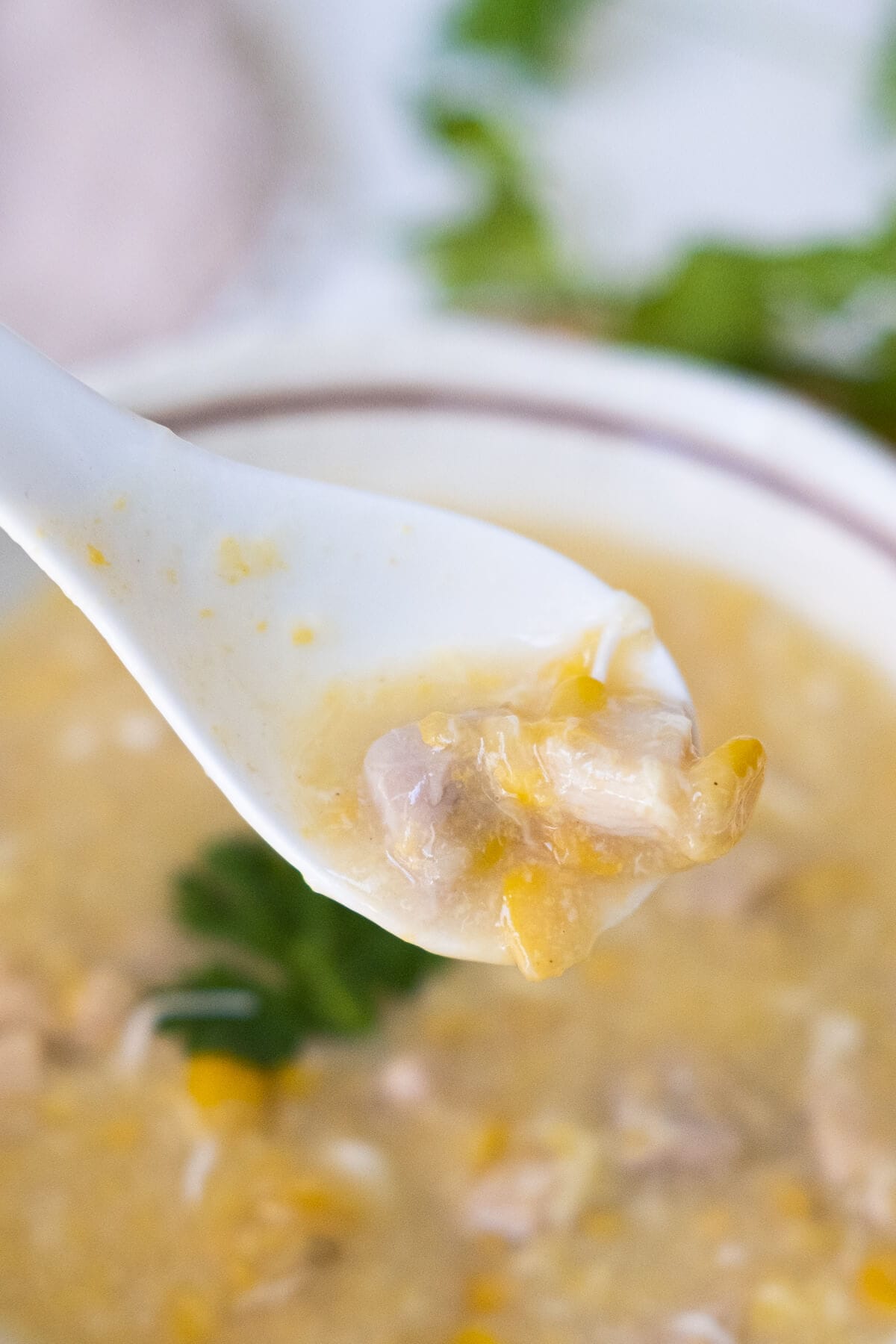 Scoop the sweet corn and chicken soup with a spoon. 