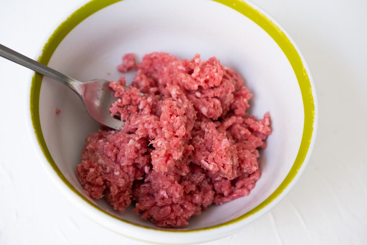 Break up the marinated ground beef in a small bowl with fork. 